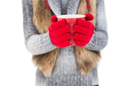 Woman in winter clothes holding a mug on white background Stock Photo - Budget Royalty-Free & Subscription, Code: 400-07901766