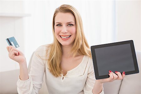 simsearch:400-07474252,k - Pretty blonde shopping online with tablet at home in the living room Stock Photo - Budget Royalty-Free & Subscription, Code: 400-07901913