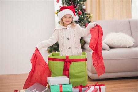 Cute little girl sitting in giant christmas gift at home in the living room Stock Photo - Budget Royalty-Free & Subscription, Code: 400-07902127