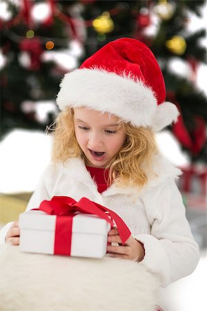 simsearch:400-07753751,k - Festive little girl looking at gift on white background Stock Photo - Budget Royalty-Free & Subscription, Code: 400-07902171