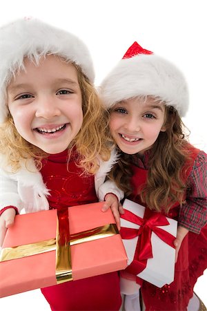 simsearch:400-07902186,k - Festive little siblings smiling at camera holding gifts on white background Foto de stock - Super Valor sin royalties y Suscripción, Código: 400-07902185