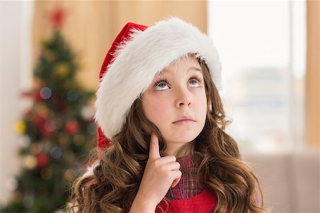 simsearch:400-07902186,k - Festive little girl thinking and looking up at home in the living room Foto de stock - Super Valor sin royalties y Suscripción, Código: 400-07902188