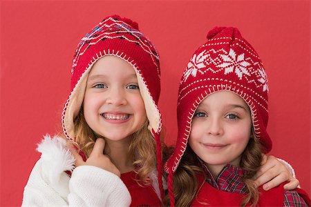 simsearch:400-05352235,k - Festive little girls smiling at camera on red background Photographie de stock - Aubaine LD & Abonnement, Code: 400-07902197