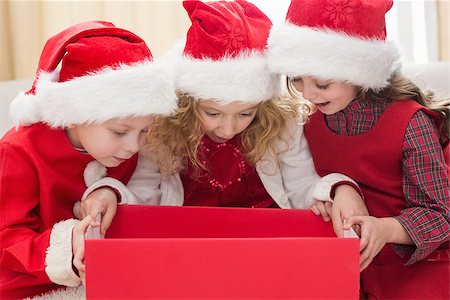 simsearch:400-07753751,k - Festive little siblings looking at gift at home in the living room Stock Photo - Budget Royalty-Free & Subscription, Code: 400-07902192