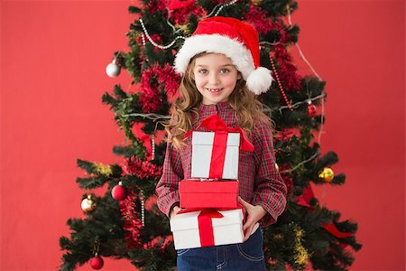 simsearch:400-07753751,k - Festive little girl holding gifts on red background Stock Photo - Budget Royalty-Free & Subscription, Code: 400-07902229