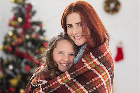 Festive mother and daughter wrapped in blanket at home in the living room Stock Photo - Budget Royalty-Free & Subscription, Code: 400-07902260