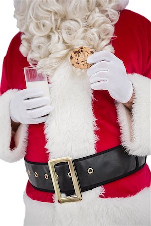 Santa holding glass of milk and cookie on white background Foto de stock - Super Valor sin royalties y Suscripción, Código: 400-07902406