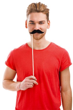 Handsome young man holding a fake moustache in front of his hace Stock Photo - Budget Royalty-Free & Subscription, Code: 400-07903119