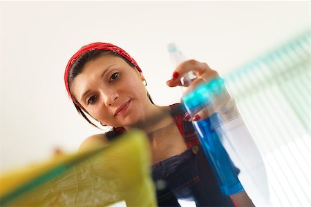 simsearch:673-02139120,k - Young hispanic woman at home, doing chores and housekeeping, wiping glass table in living room Stock Photo - Budget Royalty-Free & Subscription, Code: 400-07903324