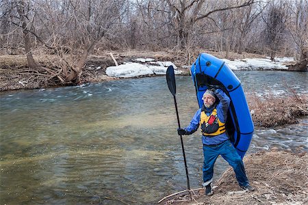 simsearch:400-07176700,k - senior male carrying a packraft (one-person light raft used for expedition or adventure racing) on the shore of Cache la Poudre River in Fort Collins, Colorado, winter or early spring scenery Foto de stock - Super Valor sin royalties y Suscripción, Código: 400-07914220