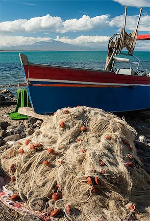 sicily etna - Drift net and a fishing boat in a small harbour of the sicilian coast with clouds and Mount Etna in the background Photographie de stock - Aubaine LD & Abonnement, Code: 400-07914776