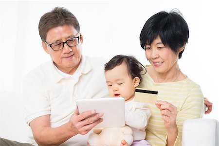 Asian family online shopping indoor, grandparents and grandchild living lifestyle at home. Stock Photo - Budget Royalty-Free & Subscription, Code: 400-07915137