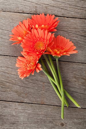 simsearch:400-07662543,k - Bouquet of orange gerbera flowers over wooden background Stock Photo - Budget Royalty-Free & Subscription, Code: 400-07915162