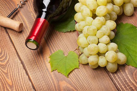 simsearch:400-08110621,k - Red wine bottle and bunch of white grapes on wooden table background Stock Photo - Budget Royalty-Free & Subscription, Code: 400-07915193