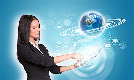 simsearch:400-07821752,k - Beautiful businesswomen in suit using digital tablet. Earth and hexagons with icons. Element of this image furnished by NASA Foto de stock - Royalty-Free Super Valor e Assinatura, Número: 400-07915435