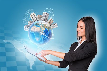 simsearch:400-07821752,k - Beautiful businesswomen in suit using digital tablet. Earth with buildings. World map and chessboard as backdrop. Element of this image furnished by NASA Foto de stock - Royalty-Free Super Valor e Assinatura, Número: 400-07915439