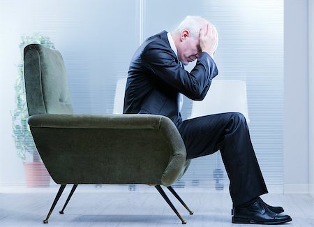 suicide - business man holding his head with his hands because of his negative feelings Stock Photo - Budget Royalty-Free & Subscription, Code: 400-07916223