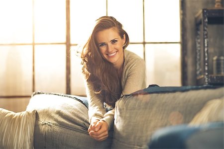 Portrait of happy young woman in loft apartment Stock Photo - Budget Royalty-Free & Subscription, Code: 400-07916448
