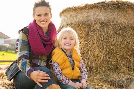 simsearch:400-07916492,k - Portrait of happy mother and child sitting on haystack Stock Photo - Budget Royalty-Free & Subscription, Code: 400-07916474