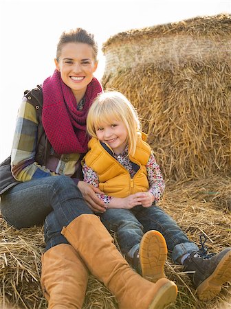 simsearch:400-07916492,k - Portrait of happy mother and child sitting on haystack Stock Photo - Budget Royalty-Free & Subscription, Code: 400-07916475