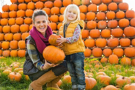 family on ranch - Portrait of happy mother and child choosing pumpkins Stock Photo - Budget Royalty-Free & Subscription, Code: 400-07916492