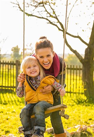 family on ranch - Portrait of smiling mother and child on swing Stock Photo - Budget Royalty-Free & Subscription, Code: 400-07916504