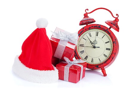 Christmas clock, gift boxes and santa hat. Isolated on white background Stock Photo - Budget Royalty-Free & Subscription, Code: 400-07917430
