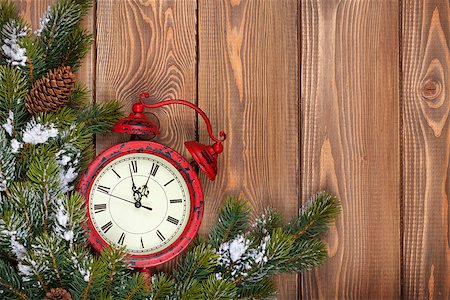 Christmas wooden background with clock, snow fir tree and copy space Stock Photo - Budget Royalty-Free & Subscription, Code: 400-07917440