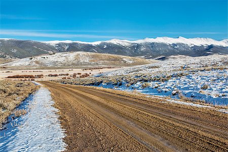 dirt backcountry road with  snowy Medicine Bow Mountains in background, North Park near Walden, Colorado, late fall scenery Stock Photo - Budget Royalty-Free & Subscription, Code: 400-07917624