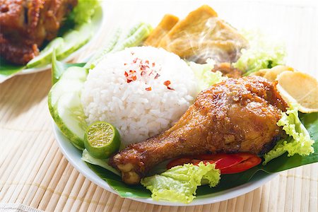 raw chicken dishes - Popular Indonesian local food nasi ayam penyet, indonesian fried chicken rice with sambal belacan. Fresh hot with steam smoke. Stock Photo - Budget Royalty-Free & Subscription, Code: 400-07917691