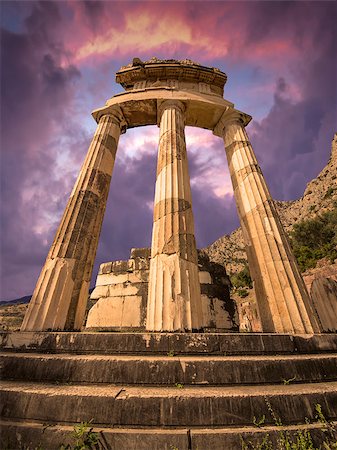 The Tholos at the sanctuary of Athena Pronoiat Delphi is a circular building that was constructed between 380 and 360 BCE. It consisted of 20 Doric columns arranged with an exterior diameter of 14.76 meters, with 10 Corinthian columns in the interior. Fotografie stock - Microstock e Abbonamento, Codice: 400-07917788