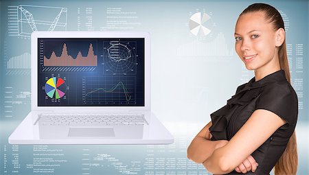 simsearch:400-08158930,k - Beautiful businesswoman in dress smiling and looking at camera. Open laptop with graphs on screen are located near. Hi-tech graphs as backdrop Stock Photo - Budget Royalty-Free & Subscription, Code: 400-07918931