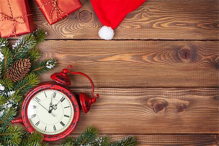 Christmas background with clock, snow fir tree and gift boxes over wood Stock Photo - Budget Royalty-Free & Subscription, Code: 400-07919364