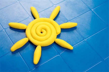 sun of modeling clay on a blue plastic table Stock Photo - Budget Royalty-Free & Subscription, Code: 400-07919763