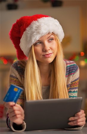 simsearch:400-06419734,k - Portrait of thoughtful teenager girl in santa hat with credit card using tablet pc Stock Photo - Budget Royalty-Free & Subscription, Code: 400-07924193