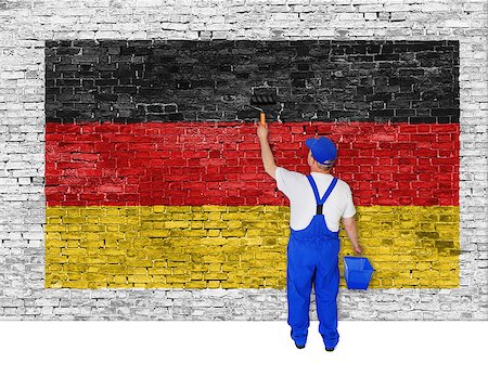 simsearch:400-07933897,k - Painter covers white brick wall with flag of Germany Fotografie stock - Microstock e Abbonamento, Codice: 400-07924634