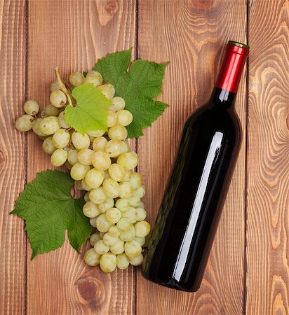 simsearch:400-08110621,k - Red wine bottle and bunch of white grapes on wooden table background Stock Photo - Budget Royalty-Free & Subscription, Code: 400-07925235