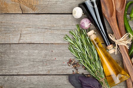 Herbs, spices and seasoning with utensils over wooden table background with copy space Stock Photo - Budget Royalty-Free & Subscription, Code: 400-07925279