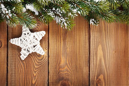 pines stars - Christmas fir tree and star shape decor on rustic wooden board with copy space Photographie de stock - Aubaine LD & Abonnement, Code: 400-07925272