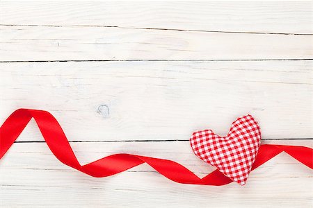Valentines day toy heart and ribbon over wooden table background with copy space Stock Photo - Budget Royalty-Free & Subscription, Code: 400-07925299