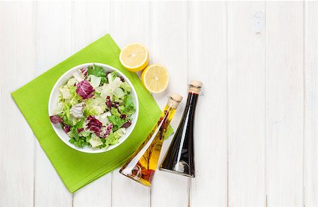 simsearch:400-06485512,k - Fresh healthy salad and condiments over white wooden table. View from above with copy space Stock Photo - Budget Royalty-Free & Subscription, Code: 400-07925306