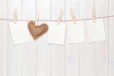 Photo frames and valentines toy heart over wooden background Foto de stock - Super Valor sin royalties y Suscripción, Código: 400-07925328