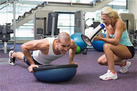 View of a female trainer assisting man with push ups at the gym Stock Photo - Budget Royalty-Free & Subscription, Code: 400-07925849