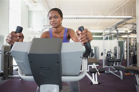 simsearch:400-07725687,k - Fit woman working out on the exercise bike at the gym Photographie de stock - Aubaine LD & Abonnement, Code: 400-07925990