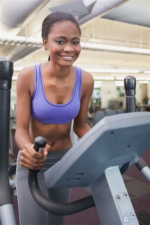 simsearch:400-07725687,k - Fit woman working out on the cross trainer at the gym Photographie de stock - Aubaine LD & Abonnement, Code: 400-07926017