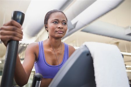 simsearch:400-07725687,k - Fit woman working out on the cross trainer at the gym Photographie de stock - Aubaine LD & Abonnement, Code: 400-07926010