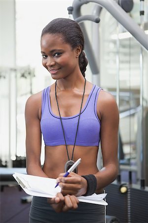 simsearch:400-07777565,k - Fit personal trainer smiling at camera at the gym Stockbilder - Microstock & Abonnement, Bildnummer: 400-07926029