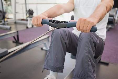 simsearch:400-07725772,k - Fit man working out on rowing machine at the gym Photographie de stock - Aubaine LD & Abonnement, Code: 400-07926048