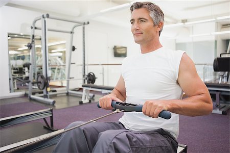 simsearch:400-07725931,k - Fit man working out on rowing machine at the gym Photographie de stock - Aubaine LD & Abonnement, Code: 400-07926050