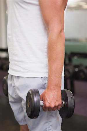 simsearch:400-08017381,k - Fit man lifting heavy black dumbbell at the gym Photographie de stock - Aubaine LD & Abonnement, Code: 400-07926074